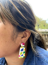 Load image into Gallery viewer, Ezrah wearing Barcelona Angled Rectangle on left ear Barcelona Angled Rectangle + Square Stud  1 L x 0.125 W x 2 H 18K Gold Plated Surgical Steel Earring Posts Silicone backings by Pinwheel Clay
