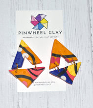 Load image into Gallery viewer, Cape Town Triangles  1.5 L x 0.125 W x 2 H 18K Gold Plated Surgical Steel Earring Posts Silicone backings on earring card by Pinwheel Clay
